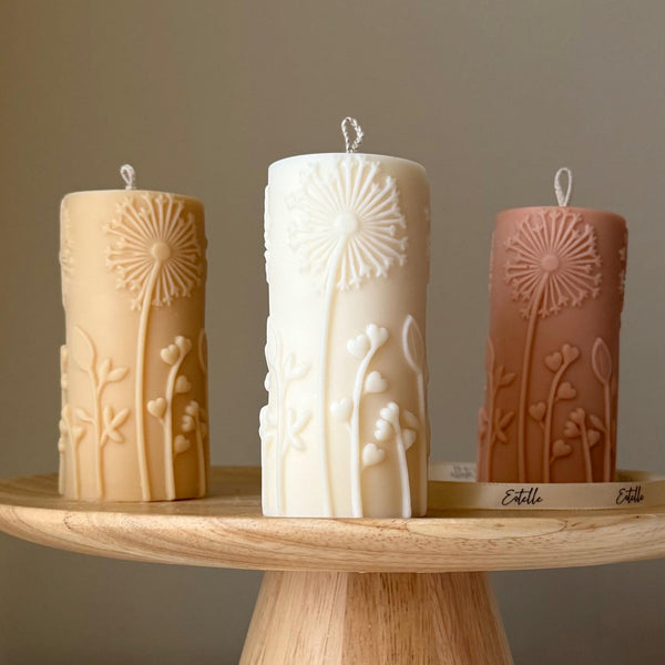 Oh Canada Gifts set of three sculptural soy wax pillar candles with embossed dandelion botanical motifs in neutral tones