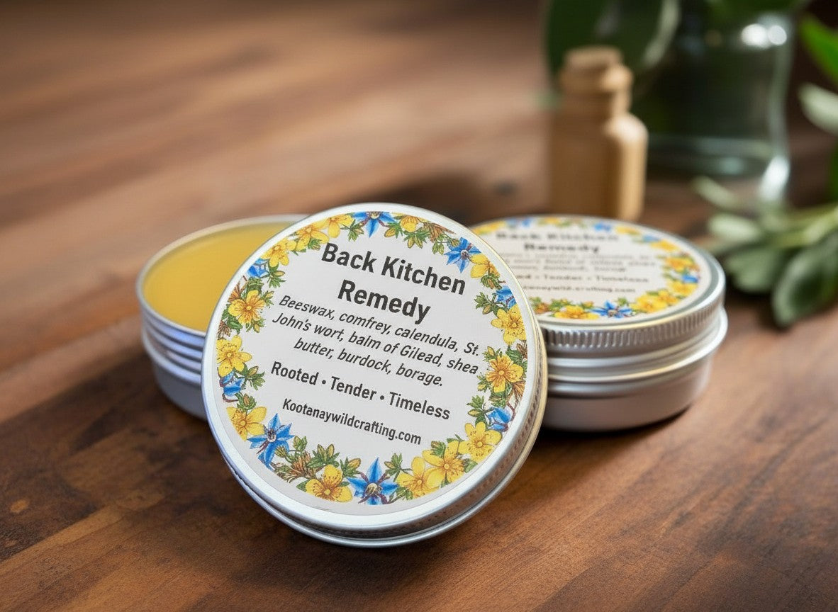 Oh Canada Gifts Back Kitchen Heritage Salve in a round metal tin with a floral label on a wooden surface.
