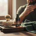 Oh Canada Gifts Bay Rum beard oil bottle on a wooden tray with a shaving brush and razor, man grooming in background.