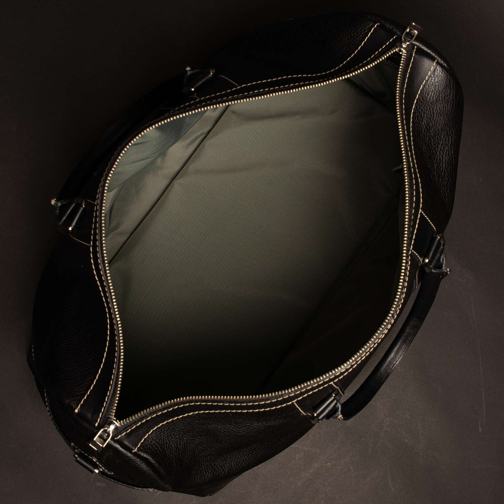 Oh Canada Gifts Shield duffle bag in black full-grain leather, shown from an open top-down view.