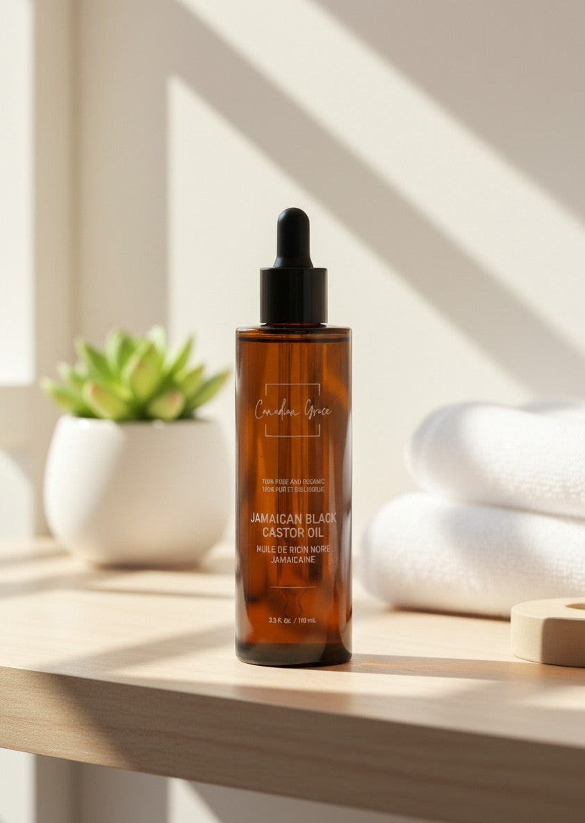 Oh Canada Gifts Canadian Grace organic Jamaican black castor oil in an amber glass dropper bottle on a wooden shelf.