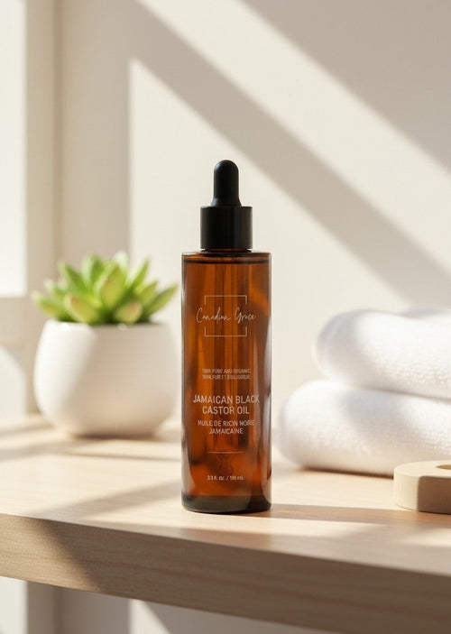 Oh Canada Gifts Canadian Grace organic Jamaican black castor oil in an amber glass dropper bottle on a wooden shelf.