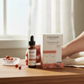 Oh Canada Gifts Cocoon Apothecary Carotene Glow antioxidant facial serum bottle and box on a wooden table