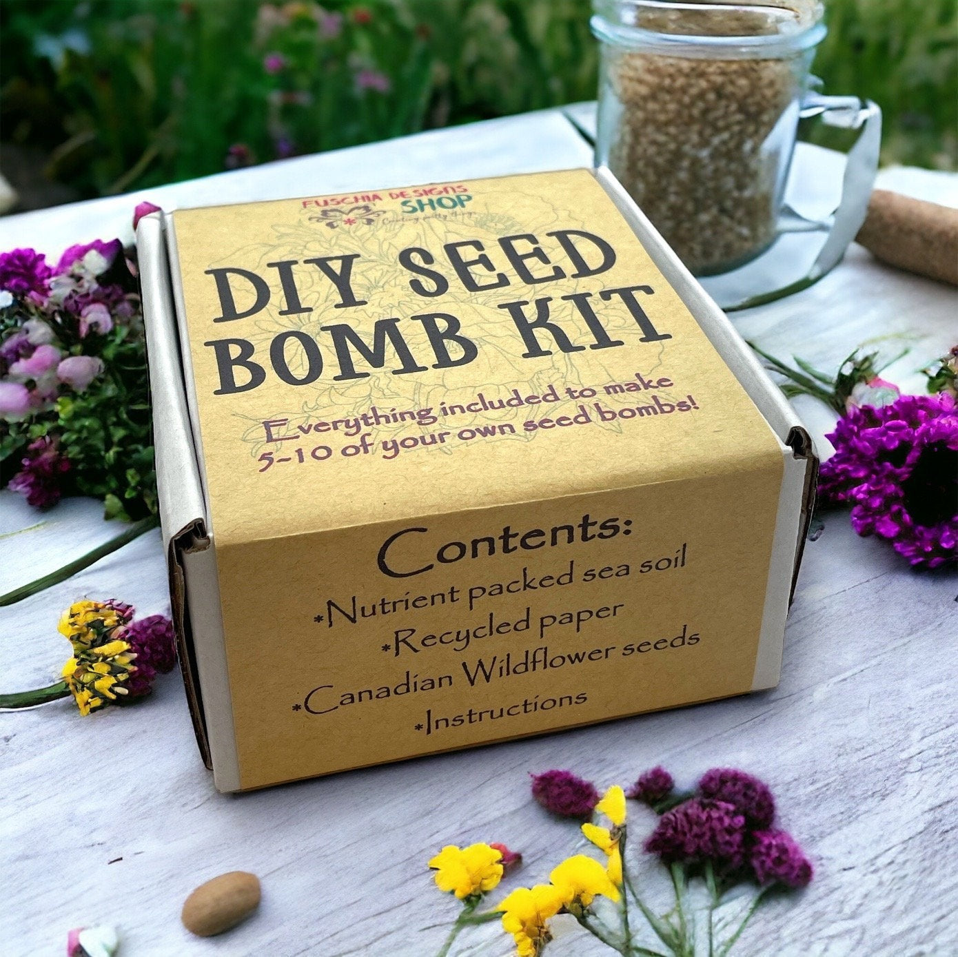 Oh Canada Gifts DIY seed bomb kit in a cardboard box with recycled paper, sea soil, and Canadian wildflower seeds.