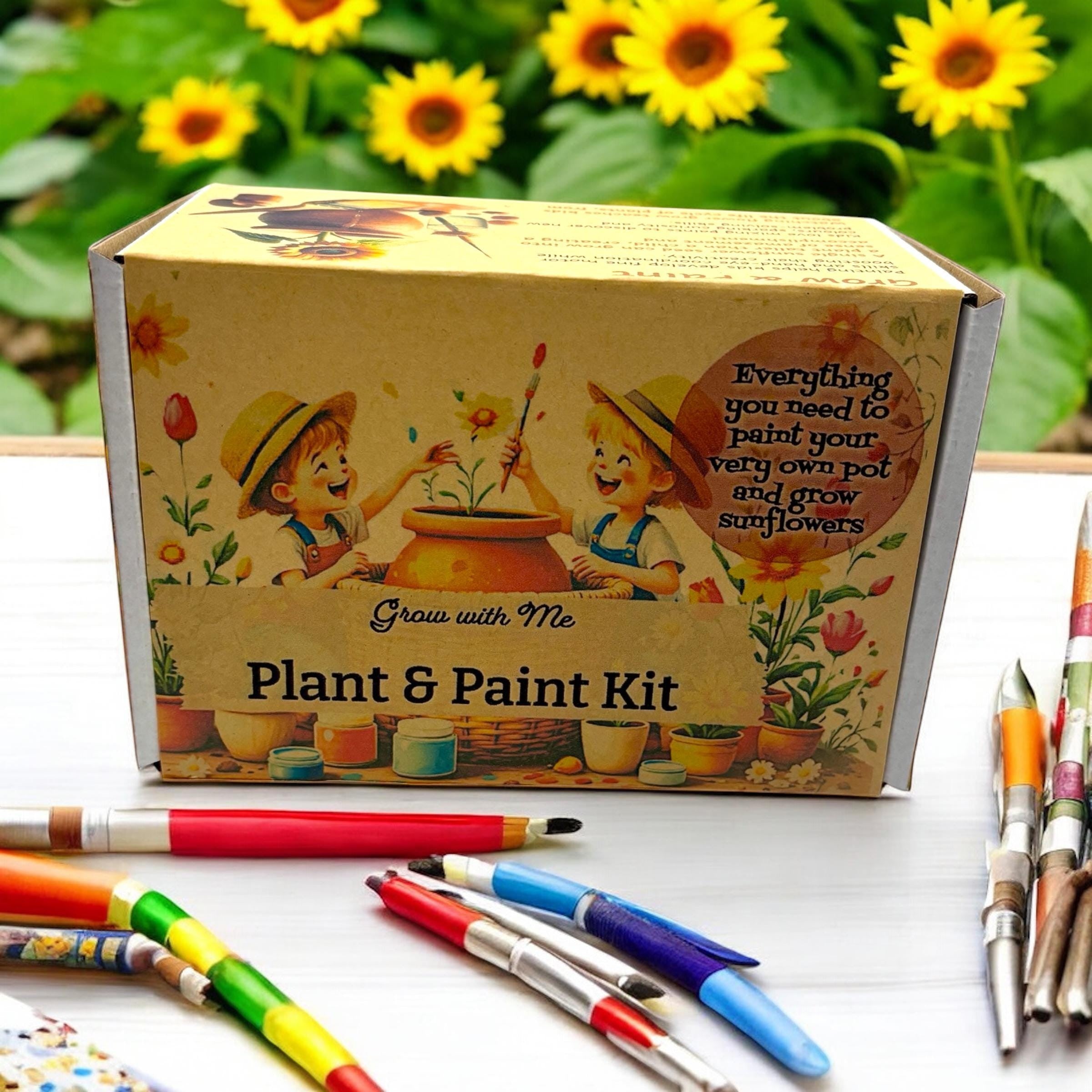 Oh Canada Gifts Paint, Plant & Grow DIY kit box with illustrated children painting a clay pot, surrounded by brushes.