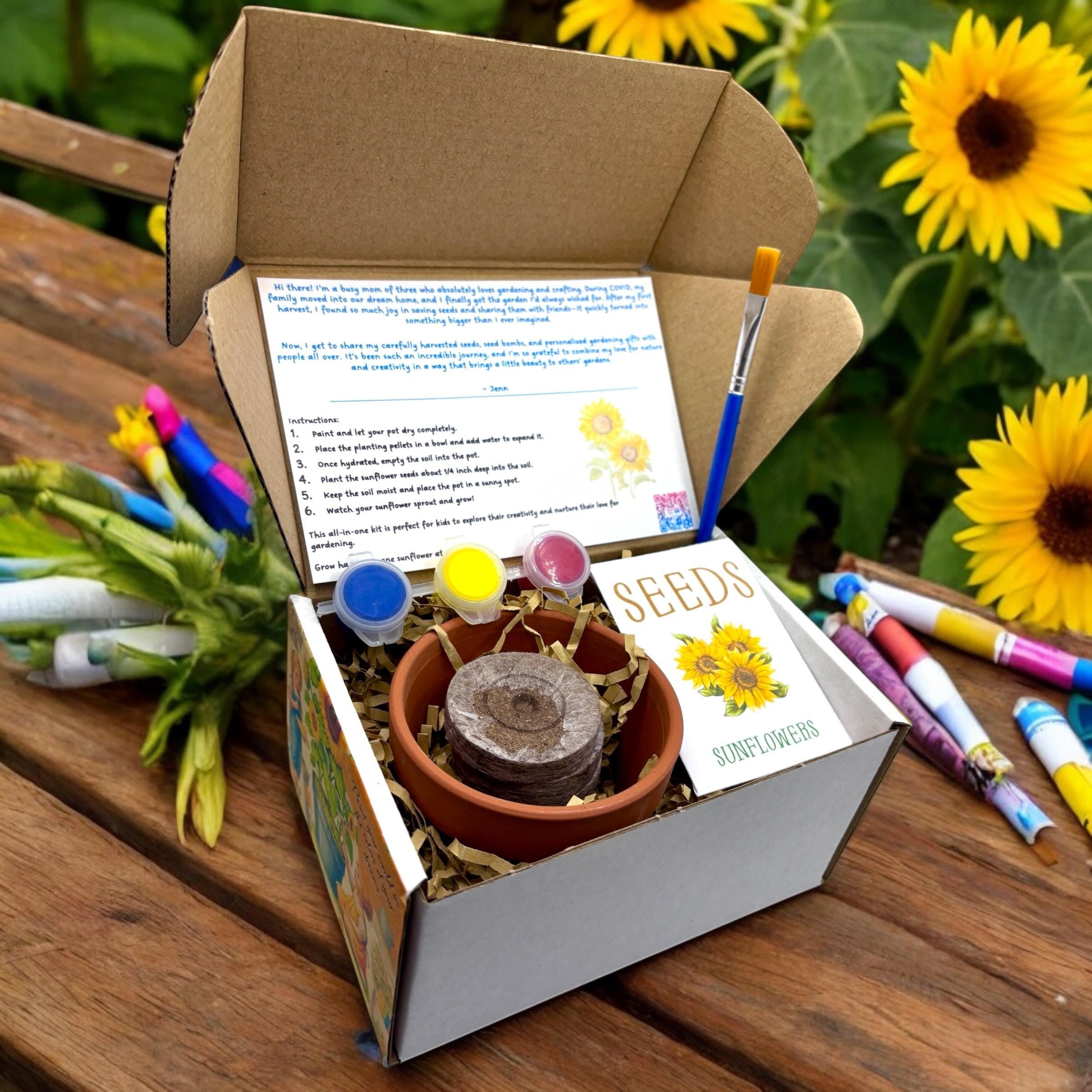 Oh Canada Gifts Paint, Plant & Grow DIY kit with clay pot, sunflower seeds, paints, and brush in an open box.