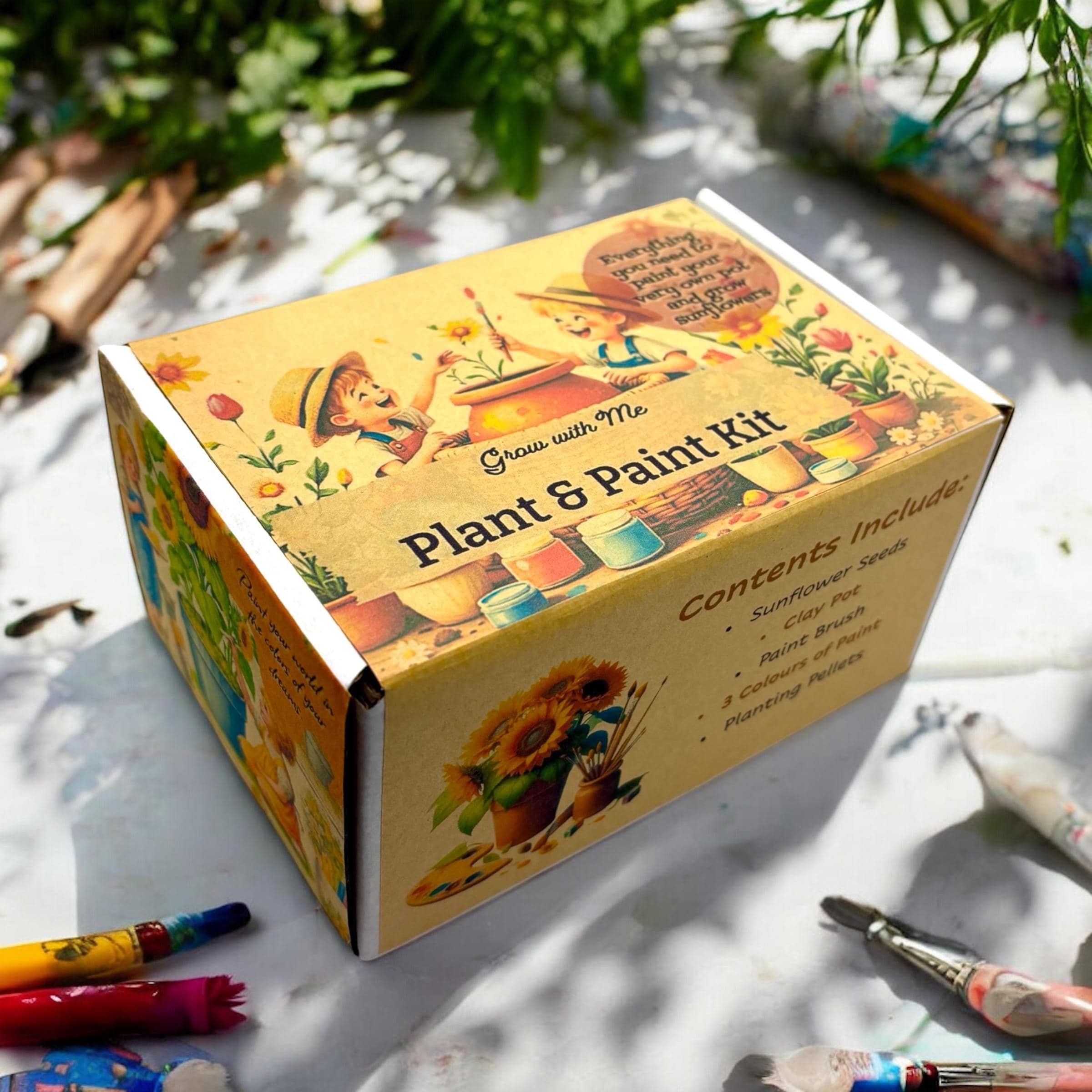 Oh Canada Gifts Paint, Plant & Grow DIY kit box featuring whimsical illustrations of children gardening and sunflowers