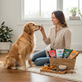Oh Canada Gifts Charcuterie Treat Box with assorted Canadian-made dog treats and a golden retriever sitting with owner