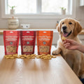 Oh Canada Gifts training treat box with three bags of Canadian-made dog treats and a golden retriever waiting for a snack