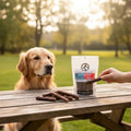 Oh Canada Gifts Elk and Beef Tripe Sticks dog treats on a wooden table with a golden retriever watching
