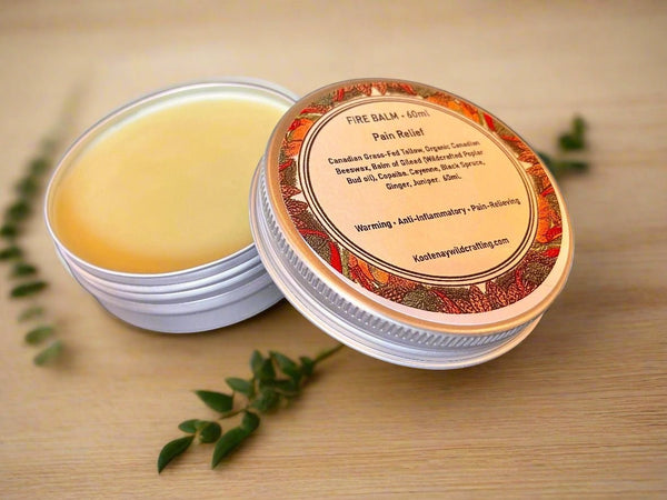 Oh Canada Gifts Fire Balm in a round metal tin with a botanical label, featuring natural tallow and herbal oils.