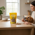 Oh Canada Gifts freeze-dried chicken treats for dogs and cats in a yellow bag on a table with a golden retriever