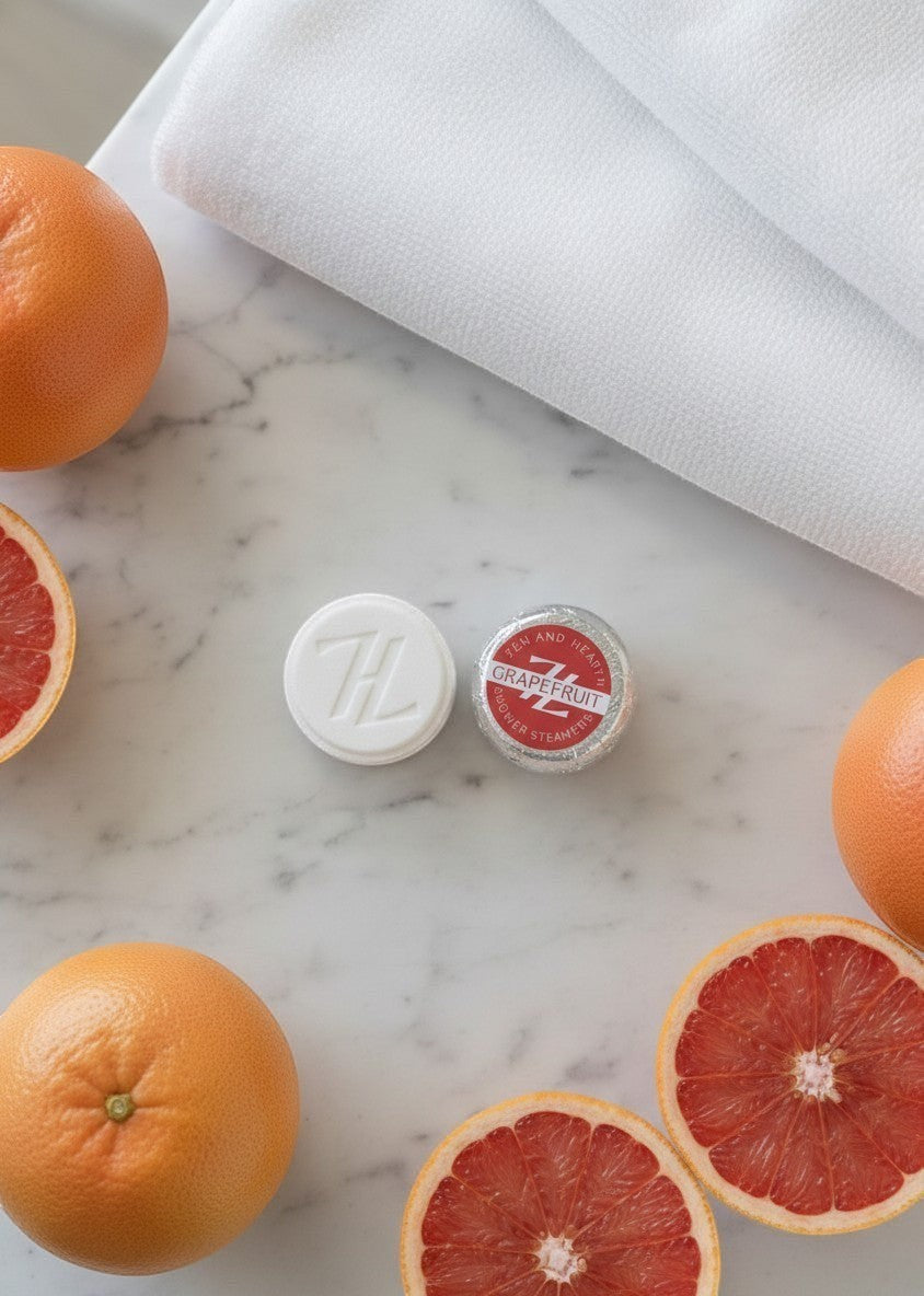 Oh Canada Gifts Zen & Hearth grapefruit shower steamers with fresh citrus fruit on a marble surface.