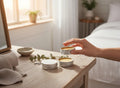 Oh Canada Gifts Kootenay Woman herbal salve collection in small metal tins on a wooden table with a hand holding one.