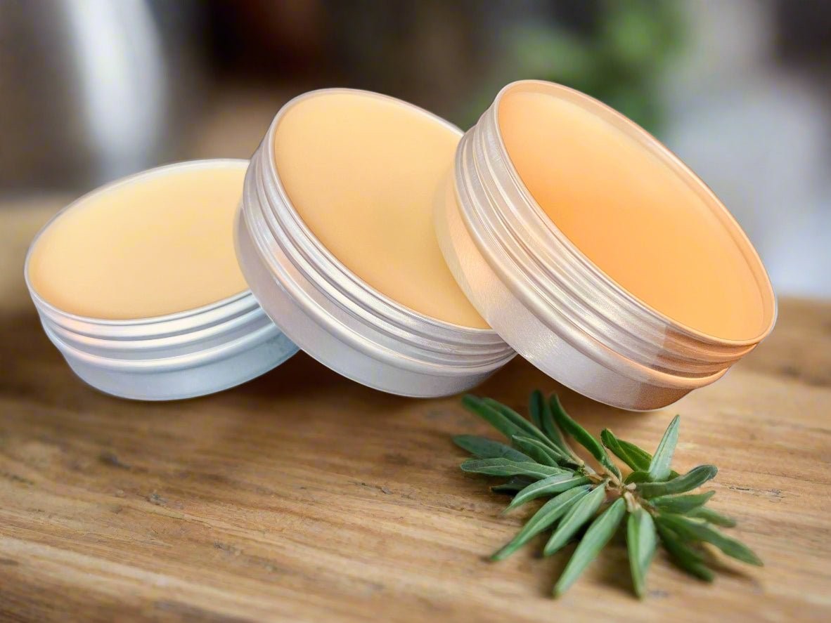 Oh Canada Gifts Heritage Salve Collection featuring three small round tins of natural herbal balms on a wooden surface.