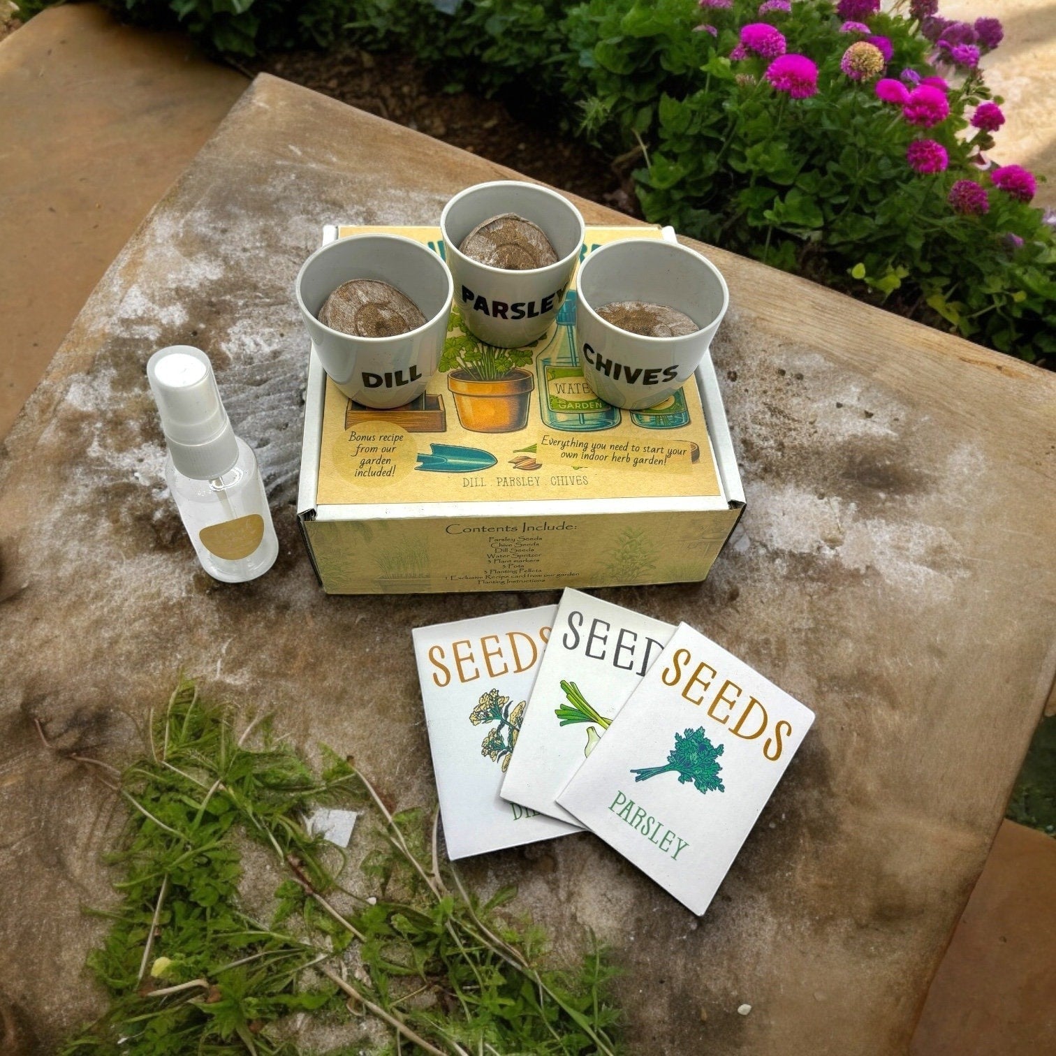 Oh Canada Gifts indoor herb garden starter kit with three labelled pots, seed packets, and a water spritzer.