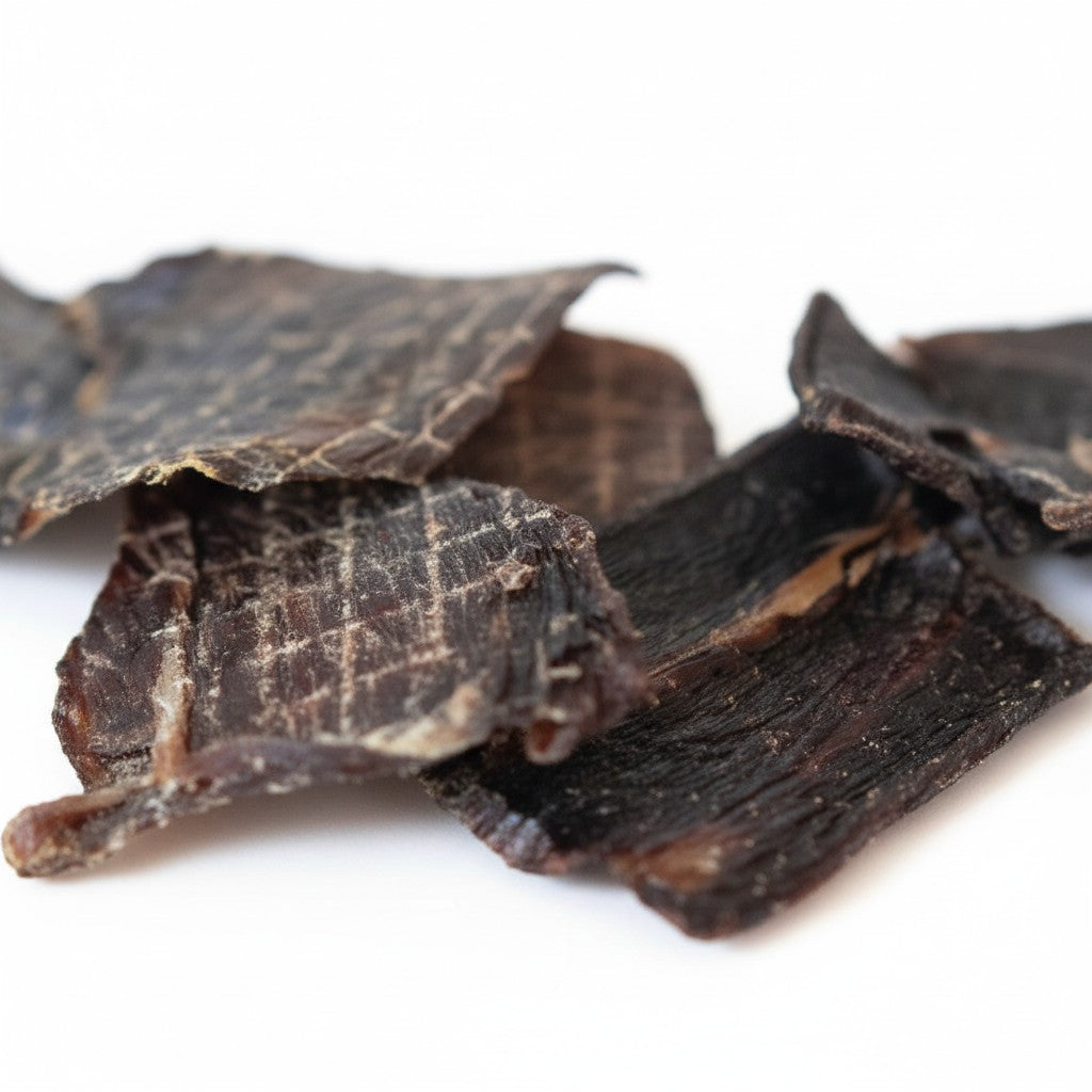 Oh Canada Gifts kangaroo jerky pieces, a high-protein, slow-cooked chewy treat for dogs on a white background.