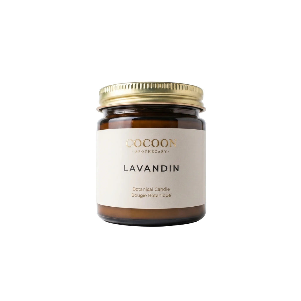 Oh Canada Gifts Cocoon Apothecary Lavandin botanical candle in an amber glass jar with a gold lid.