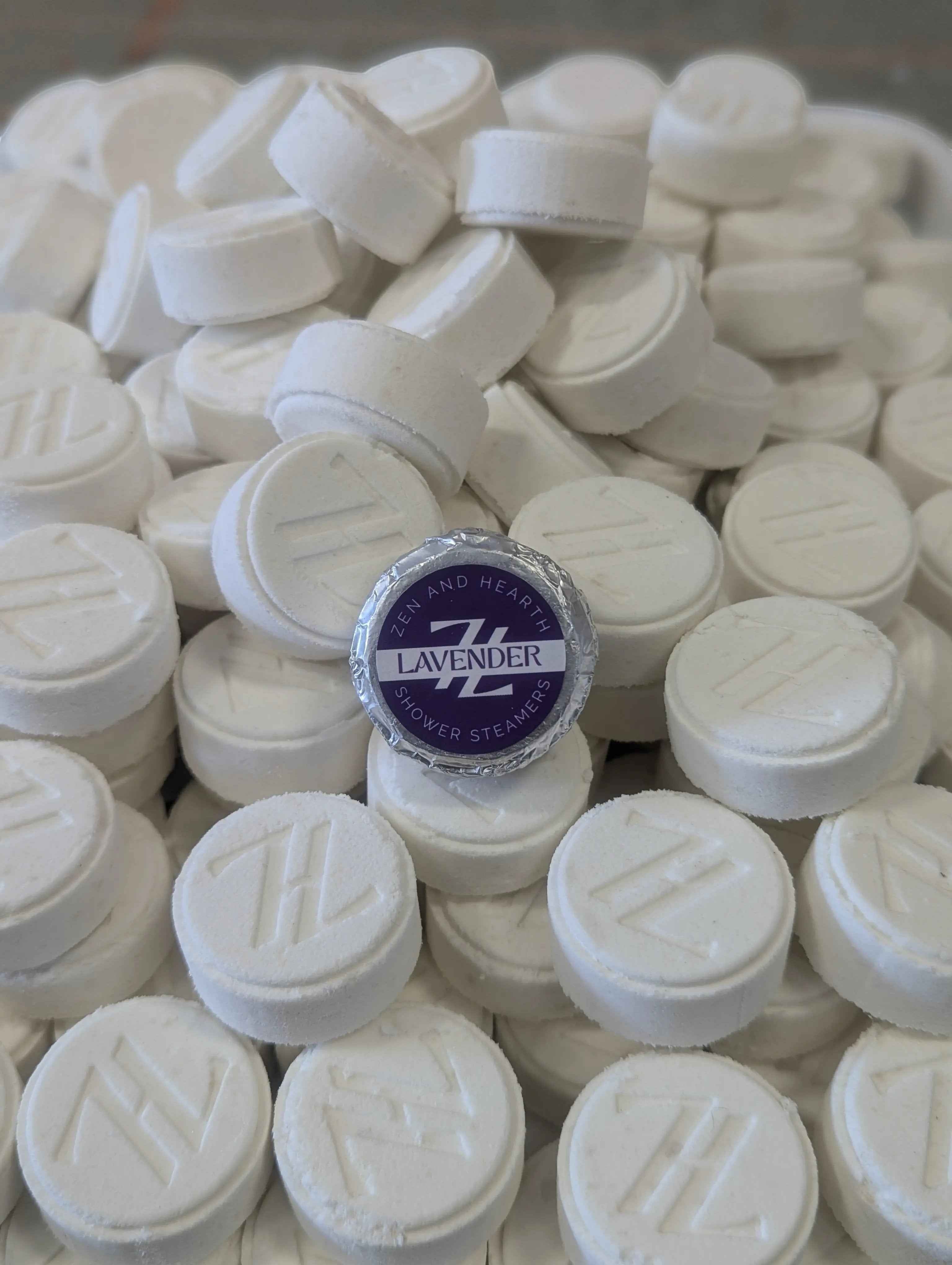 Oh Canada Gifts Zen & Hearth lavender shower steamers, white effervescent tablets with a branded purple foil label.