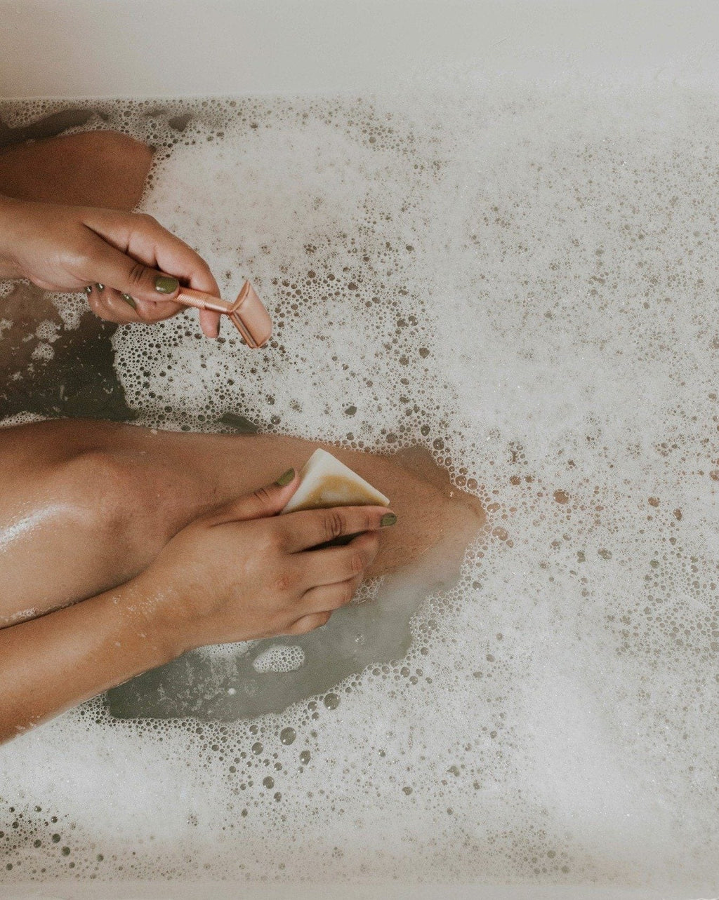 Oh Canada Gifts natural shave bar held in a soapy bath with a safety razor for a plastic-free shaving routine.