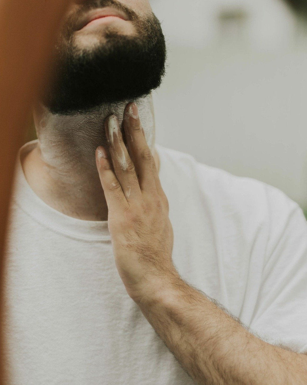 Man applying Oh Canada Gifts natural shave bar lather to his neck for a smooth, comfortable shave
