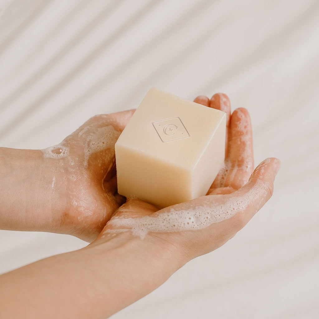 Oh Canada Gifts Patchouli Bar Soap held in hands, creating a creamy lather for a gentle, moisturizing cleanse.