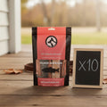 Oh Canada Gifts salmon skin strips dog treats in a bulk pack of ten bags on a wooden porch