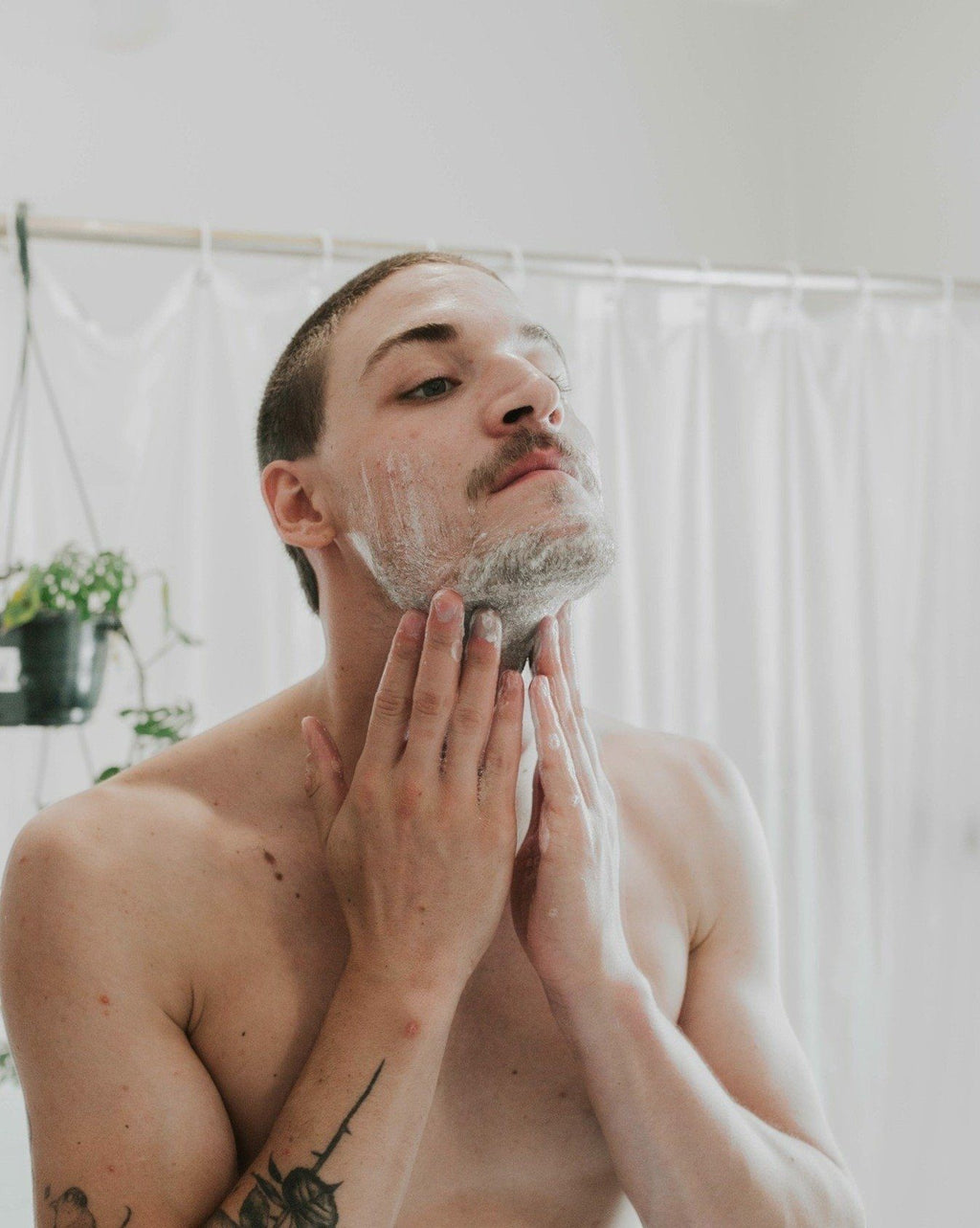 Oh Canada Gifts Shave Bar lather applied to a man's face for a smooth, moisturizing shave in a bathroom setting.