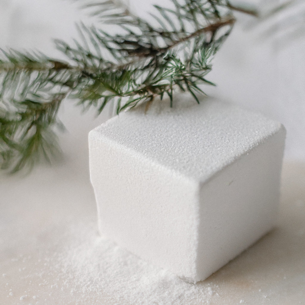 Oh Canada Gifts Spruce Flora effervescent white bath cube with a spruce branch on a light surface