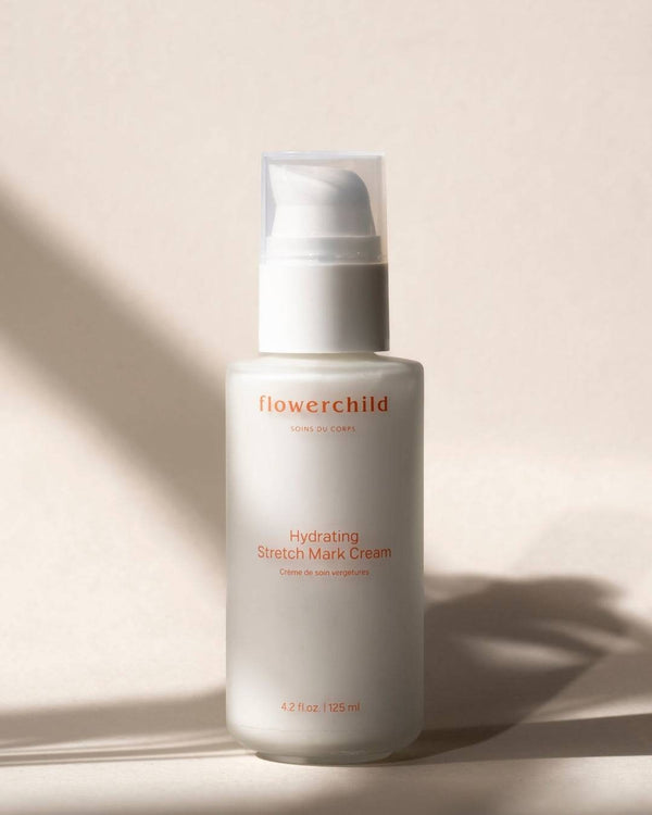 Oh Canada Gifts Flowerchild stretch mark care cream in a white pump bottle for pregnancy and postpartum skin care.