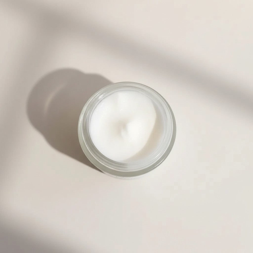 Oh Canada Gifts Cream It nourishing whipped facial moisturizer in an open glass jar with a soft, creamy texture.